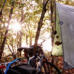 Beautiful daybreak My hammock setup and bike with the sun shining through the trees.